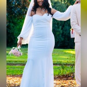 Off shoulder ruched latern sleeve mermaid hem wedding dress.